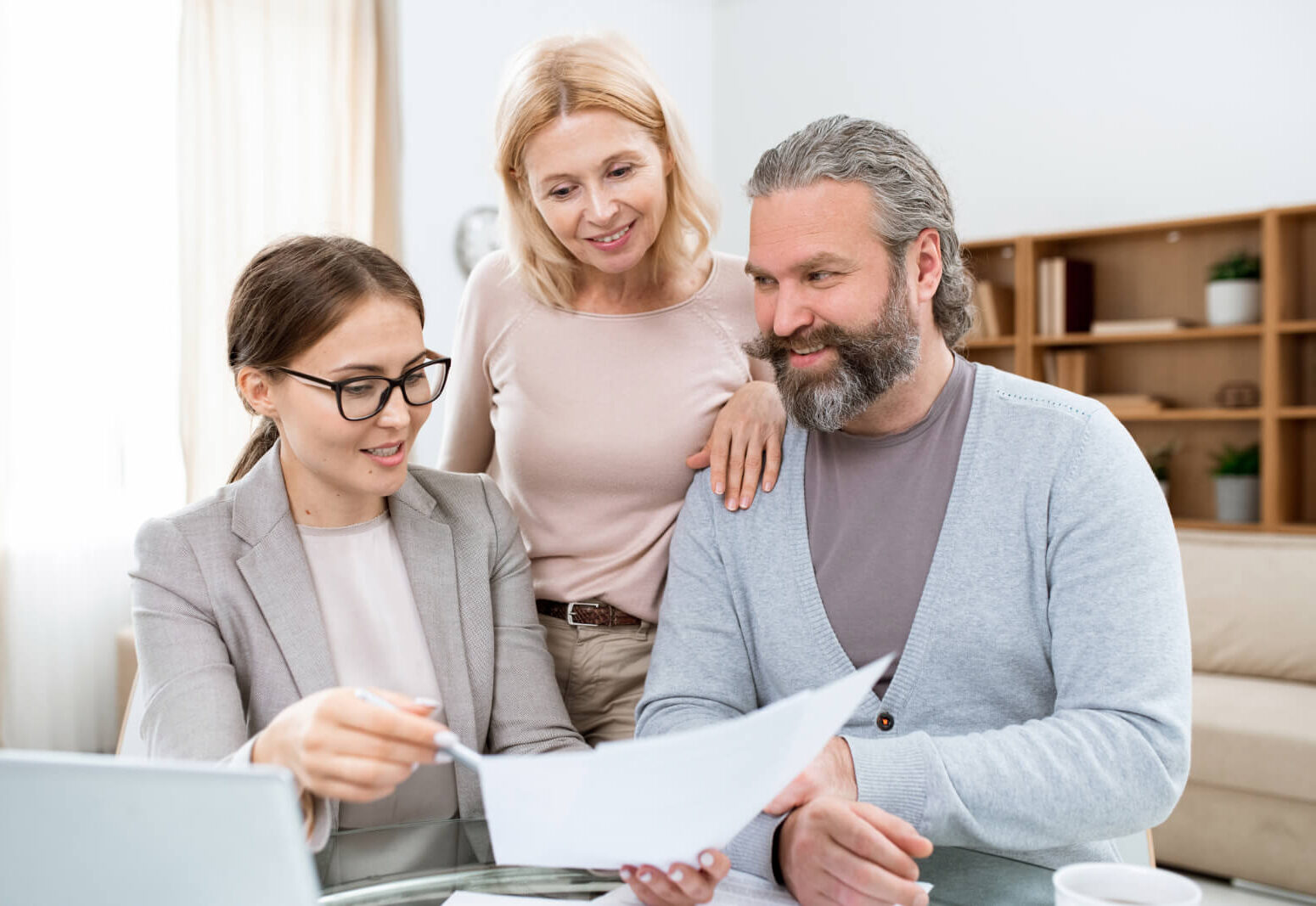 Married couple listening to a public adjuster read a document