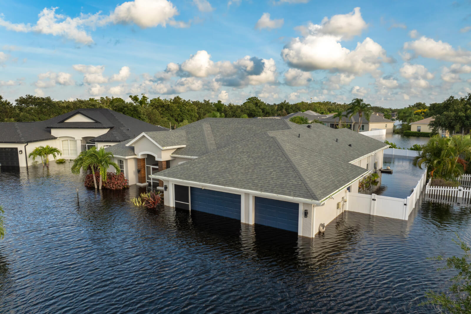 One story home surrounded by deep water caused by flood