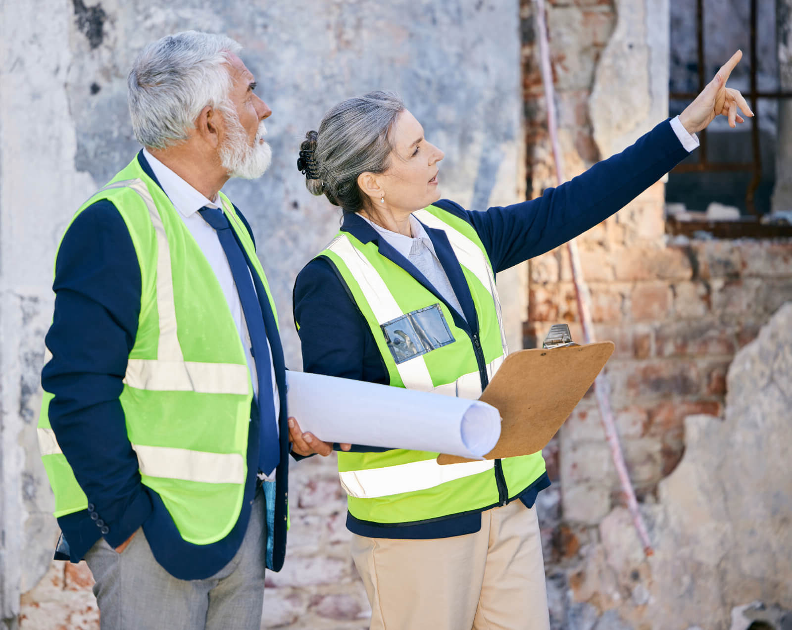 Two property appraisers inspect a severely damaged building